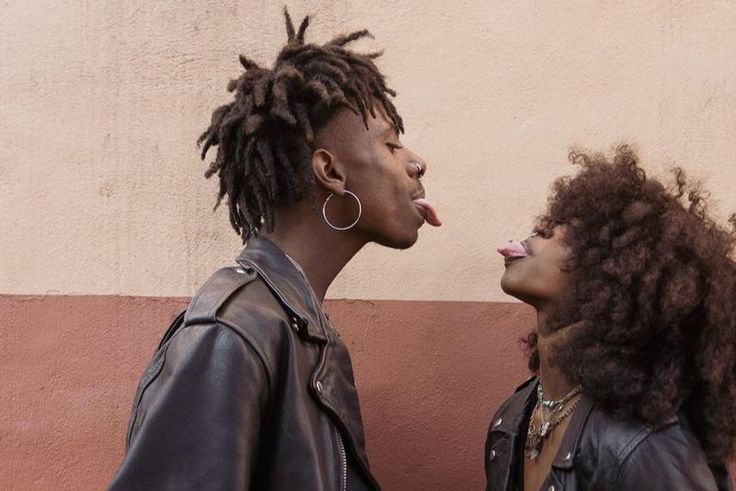 Young couple standing face to face and sticking out tongues [Image: Brian Jr Asare]