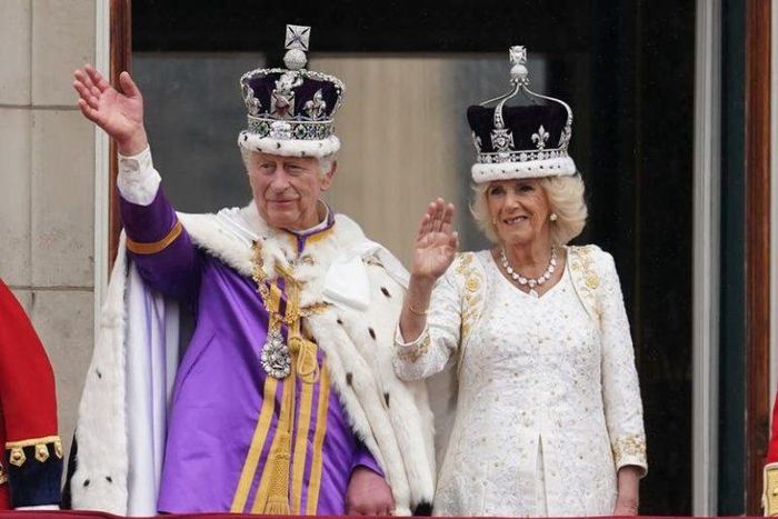 King Charles III and Queen Camilla in lavish robes and wearing their crowns return with a wave the cheers of the crowds and set the seal on their historic coronation day with a Buckingham Palace balcony appearance to acknowledge the nation..
