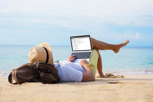 Man working while enjoying time on a beach