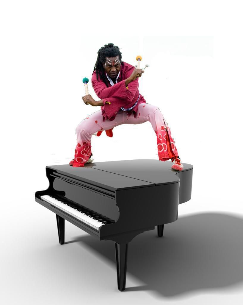 Amayo standing on a Grand Piano