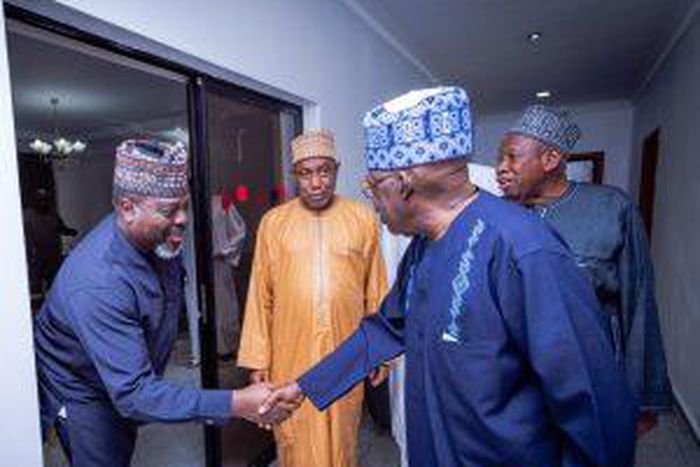 Mr Ade Omole (Left), Director of Diaspora Directorate of the defunct APC Presidential Campaign Council cPCC) in a handshake with President Bola Tinubu
