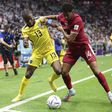 Enner Valencia (L) of Ecuador vies with Homam Ahmed of Qatar during the Group A match between Qatar and Ecuador at the 2022 FIFA World Cup on November 20, 2022.