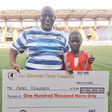 Seyi Akinwunmi presenting cheque to one of the beneficiaries