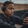 Stock photo of a Black man wearing headphones [Unsplash]