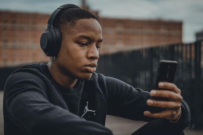 Stock photo of a Black man wearing headphones [Unsplash]