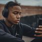 Stock photo of a Black man wearing headphones [Unsplash]