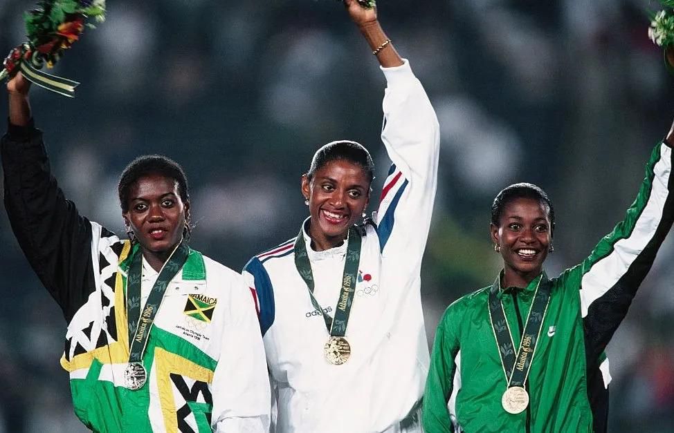 Onyali (right) on the podium after winning the 200m Bronze at Atlanta 1996