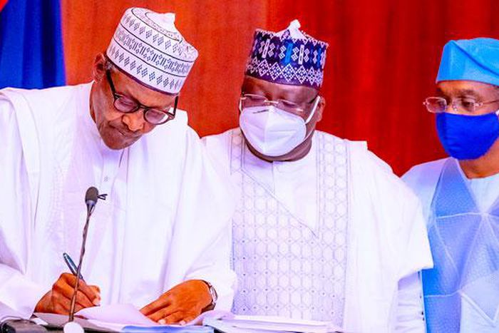 President Muhammadu Buhari with Senate President Ahmad Lawan and Speaker Femi Gbajabiamila at the signing of the Electoral Act Amendment Bill in Abuja on February 25, 2022