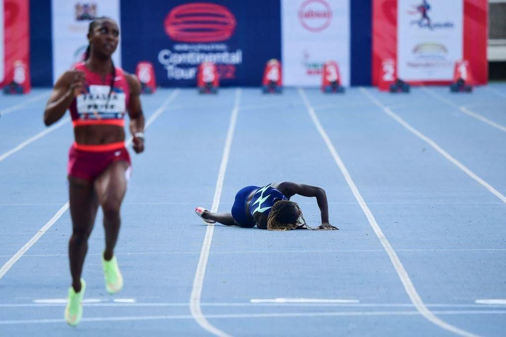 Namibia's Christine Mboma (R) stumbles as Jamaica's Shelly-Ann Fraser Pryce (L) takes the lead while competing in the women's 100m event during the Kip Keino Classic, part of the World Athletics Continental Tour 2022, at the Kasarani stadium in Nairobi...