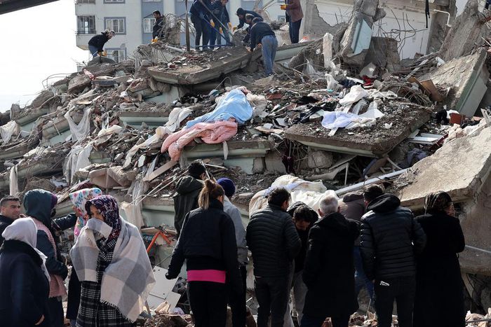 Rescuers and civilians look for survivors under the rubble of collapsed buildings in Kahramanmaras, Turkey. A 7.8-magnitude earthquake struck the country's southeast on February 7, 2023.ADEM ALTAN/AFP via Getty Images