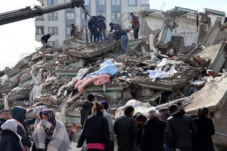 Rescuers and civilians look for survivors under the rubble of collapsed buildings in Kahramanmaras, Turkey. A 7.8-magnitude earthquake struck the country's southeast on February 7, 2023.ADEM ALTAN/AFP via Getty Images