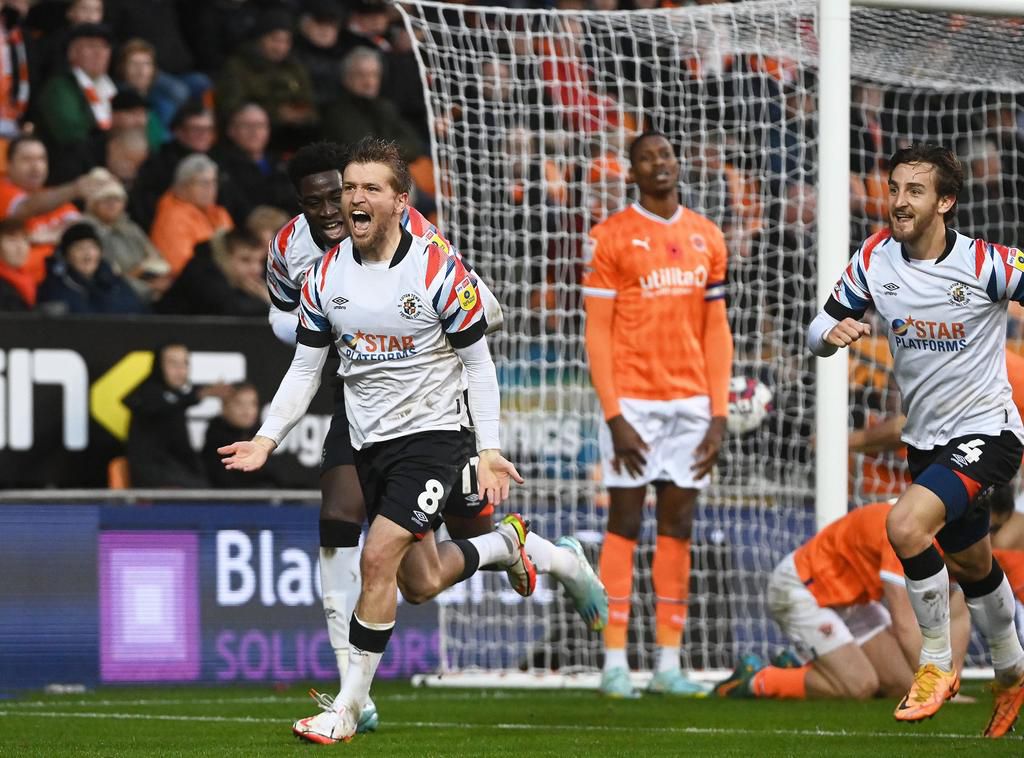 Elijah Adebayo (far left) celebrates with Berry and another Luton teammate.