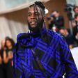 Burna Boy's outfit at the Met Gala has received praise from both fashion enthusiasts and fans, with many applauding his bold and stylish choice of attire.  [Yabaleftonline]