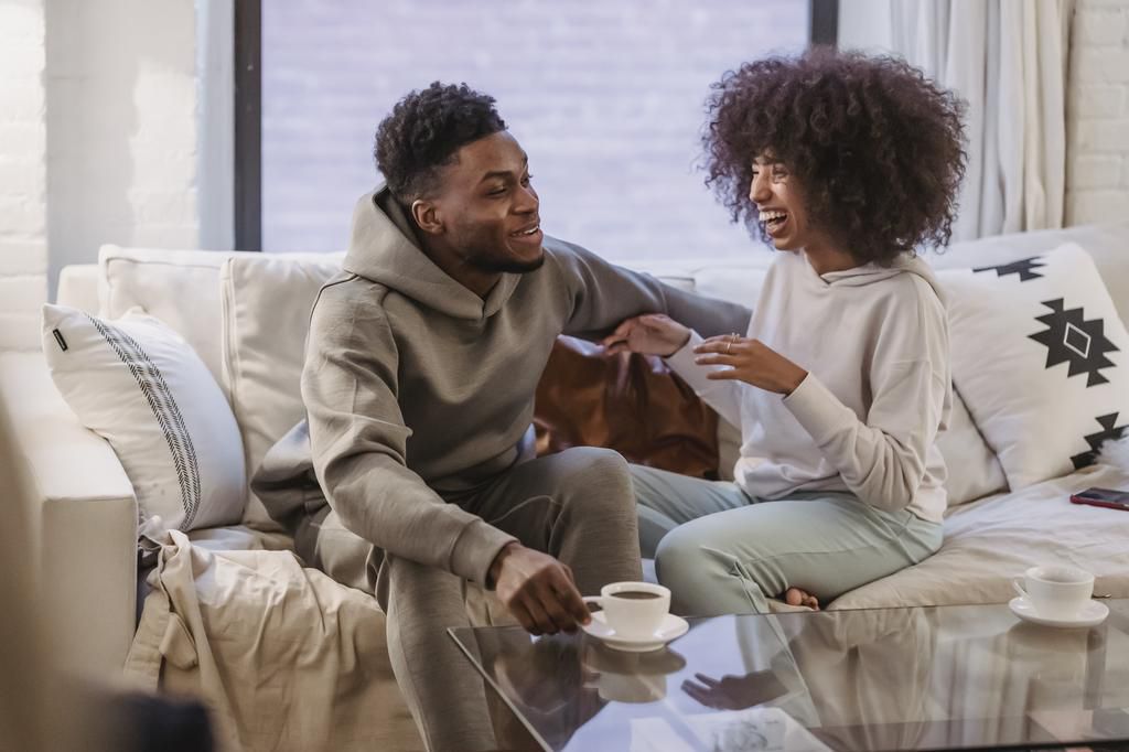 Happy couple sharing news and smiling at table