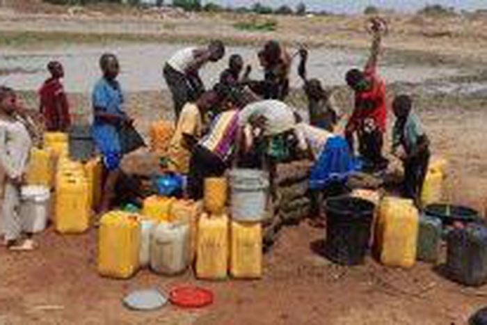 Residents struggling to fetch water from a pond in Sabongida community of Langtang South. [NAN]