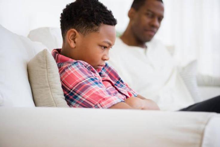 Father and son arguing in a sofa