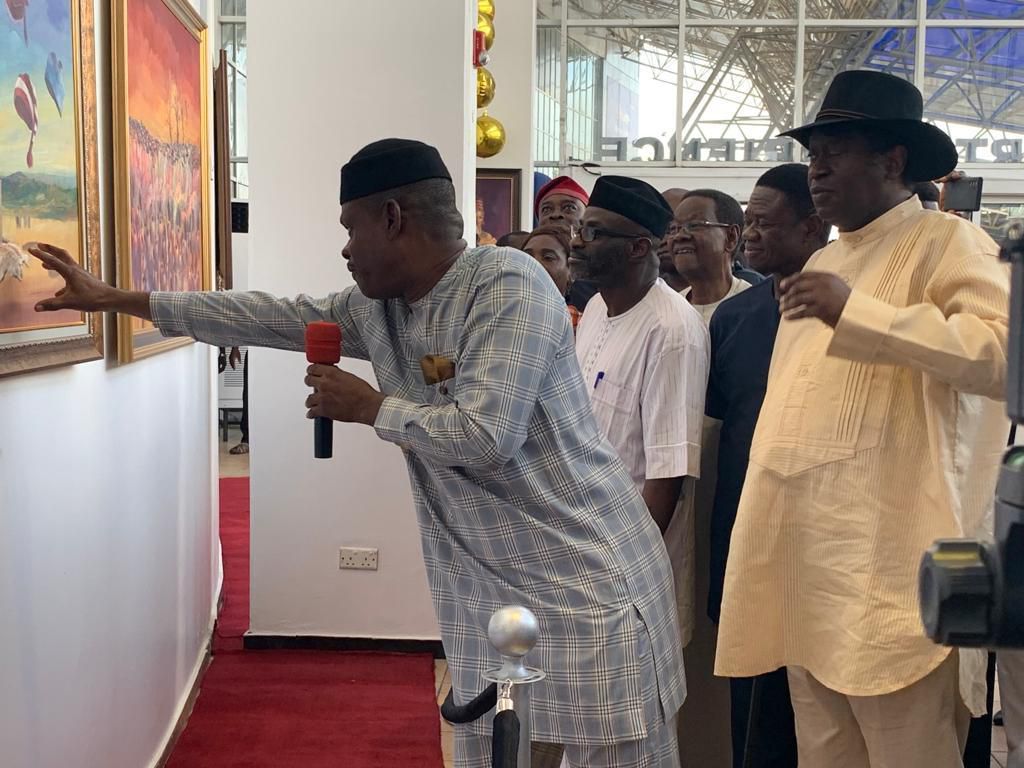 The artist, Wilson Agu explains the concepts and ideas behind the artworks to Dr. Wale Babalakin during the opening ceremony of the art gallery in MMA2. [Pulse]