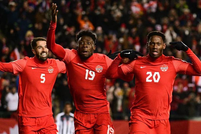 Alphonso Davies celebrating with his teammates after scoring for Canada