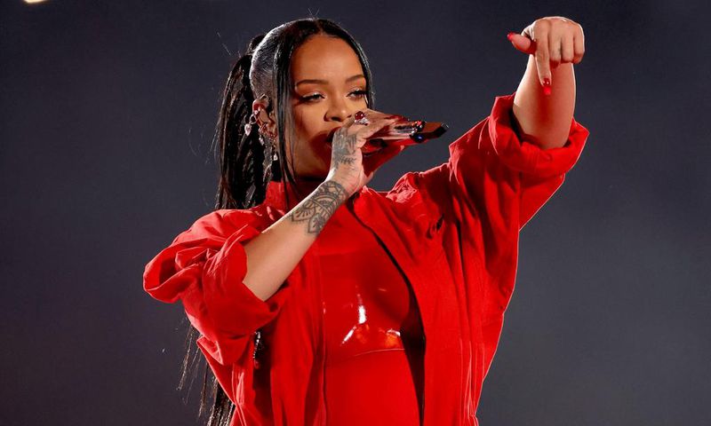 Rihanna strategically chose an unzipped red jumpsuit to reveal that she is pregnant during her 2023 performance.