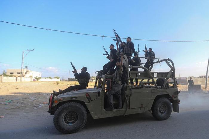 Palestinian militants ride an Israeli military vehicle that was seized by gunmen who infiltrated areas of southern Israel, in the northern Gaza Strip.Ahmed Zakot/REUTERS