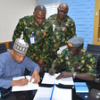 Chief of the Air Staff (CAS), Air Marshal Hasan Abubakar, signing agreement on Group Personal Accident Insurance Policy (GPAIP) with KBC Insurance Brokers Limited in Abuja [NAN]