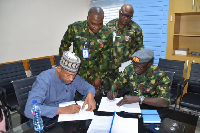 Chief of the Air Staff (CAS), Air Marshal Hasan Abubakar, signing agreement on Group Personal Accident Insurance Policy (GPAIP) with KBC Insurance Brokers Limited in Abuja [NAN]