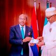 CBN Governor Godwin Emefiele and President Muhammadu Buhari during the unveiling of the redesigned naira notes. (Daily Trust)