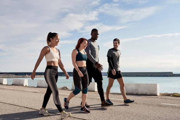 A group of men and women in training gear walking
