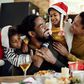 Black family celebrating Christmas [Freepik]