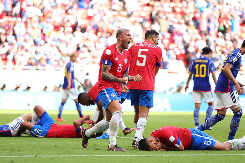 Costa Rican players celebrate their win against Japan