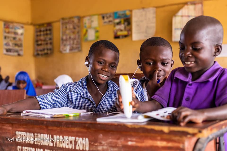 Pupils of St. Peters Anglican Primary School, Joga Orile in Ogun State interacting with talking book and pen.