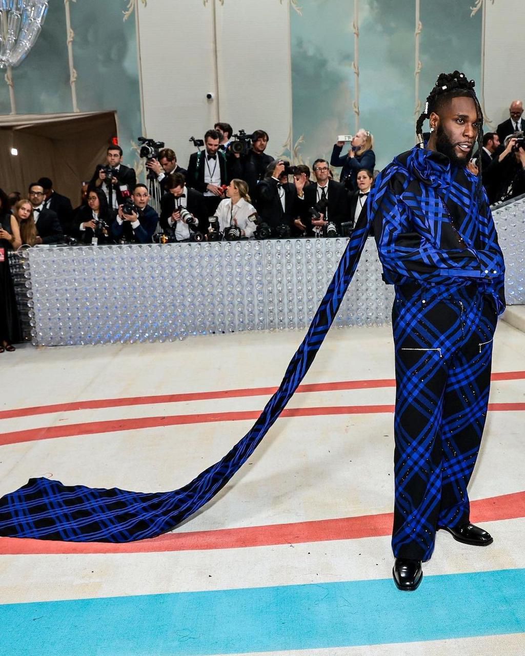 Burna Boy's outfit at the Met Gala has received praise from both fashion enthusiasts and fans, with many applauding his bold and stylish choice of attire.  [Yabaleftonline]
