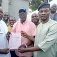 The Deputy Director General, Wasiu Eshinlokun, campaign Organisation, Pastor Gbenga Oyebode, presenting election certificate tothe former Vice Chairman, Surulere Local Government, Hon. Agboola Dabiri on behalf of Hon Lanre Okunlola