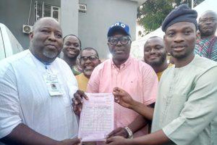 The Deputy Director General, Wasiu Eshinlokun, campaign Organisation, Pastor Gbenga Oyebode, presenting election certificate tothe former Vice Chairman, Surulere Local Government, Hon. Agboola Dabiri on behalf of Hon Lanre Okunlola