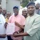 The Deputy Director General, Wasiu Eshinlokun, campaign Organisation, Pastor Gbenga Oyebode, presenting election certificate tothe former Vice Chairman, Surulere Local Government, Hon. Agboola Dabiri on behalf of Hon Lanre Okunlola