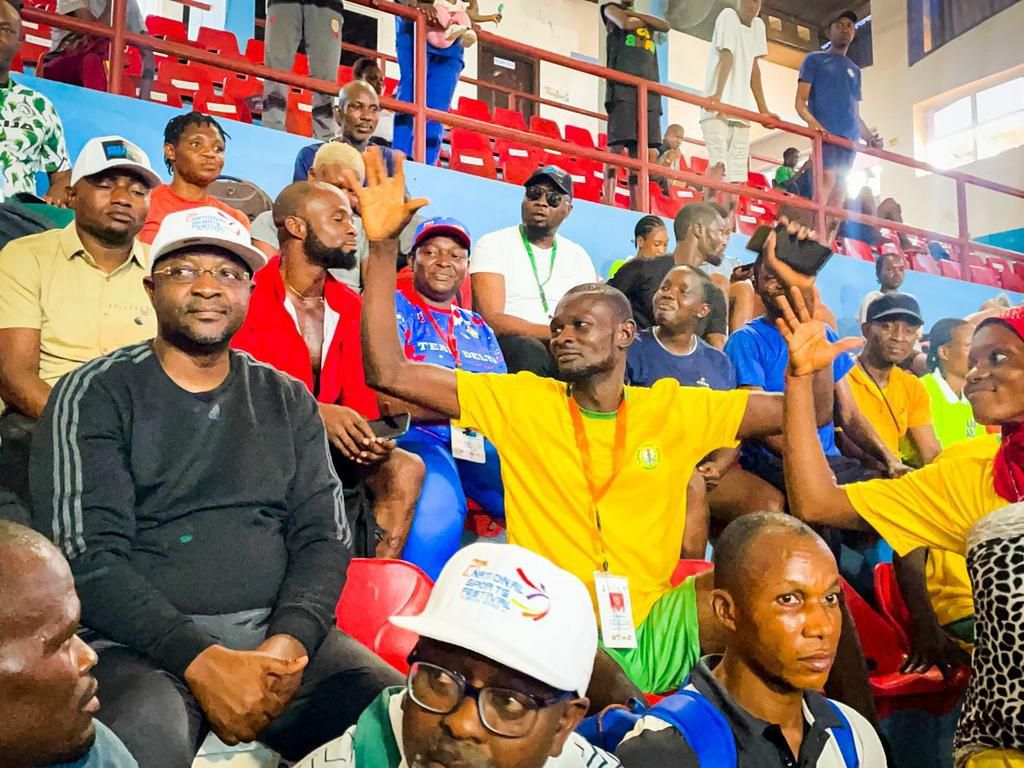 sports minister, Sunday Dare with spectators in Asaba.