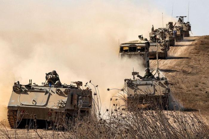 Israeli army infantry fighting vehicles (IFVs) deployed along the border with the Gaza Strip in southern Israel on October 13, 2023.JACK GUEZ
