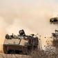 Israeli army infantry fighting vehicles (IFVs) deployed along the border with the Gaza Strip in southern Israel on October 13, 2023.JACK GUEZ