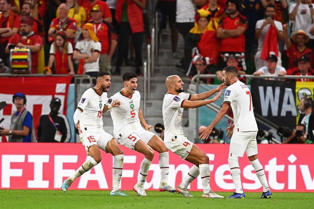 Morocco players celebrate after victory over Belgium