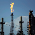 FILE - In this Thursday, Aug. 31, 2017, file photo, a flame burns at the Shell Deer Park oil refinery in Deer Park, Texas. Oil prices are plunging Sunday, March 8, 2020, amid worries that an OPEC dispute will lead a virus-weakened economy to be awash i...
