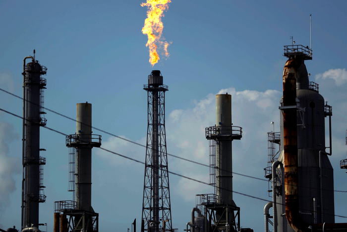 FILE - In this Thursday, Aug. 31, 2017, file photo, a flame burns at the Shell Deer Park oil refinery in Deer Park, Texas. Oil prices are plunging Sunday, March 8, 2020, amid worries that an OPEC dispute will lead a virus-weakened economy to be awash i...