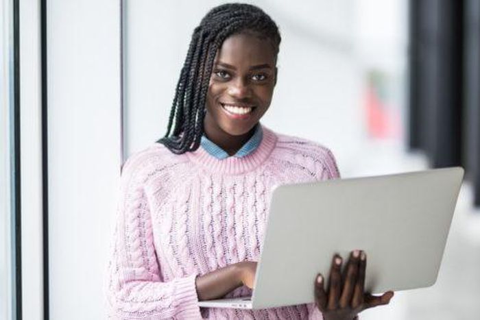 Woman working with a laptop computer [PGI]
