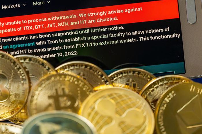 FTX logo with crypto coins with 100 Dollar bill are displayed for illustration. FTX has filed for bankruptcy in the US, seeking court protection as it looks for a way to return money to users.Jonathan Raa/NurPhoto via Getty Images