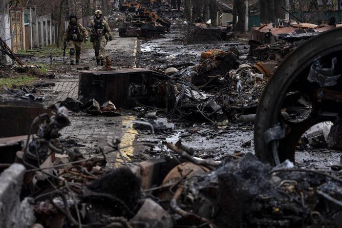 Soldiers walk amid destroyed Russian tanks in Bucha, in the outskirts of Kyiv, Ukraine, April 3, 2022.AP Photo/Rodrigo Abd, File
