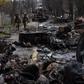 Soldiers walk amid destroyed Russian tanks in Bucha, in the outskirts of Kyiv, Ukraine, April 3, 2022.AP Photo/Rodrigo Abd, File
