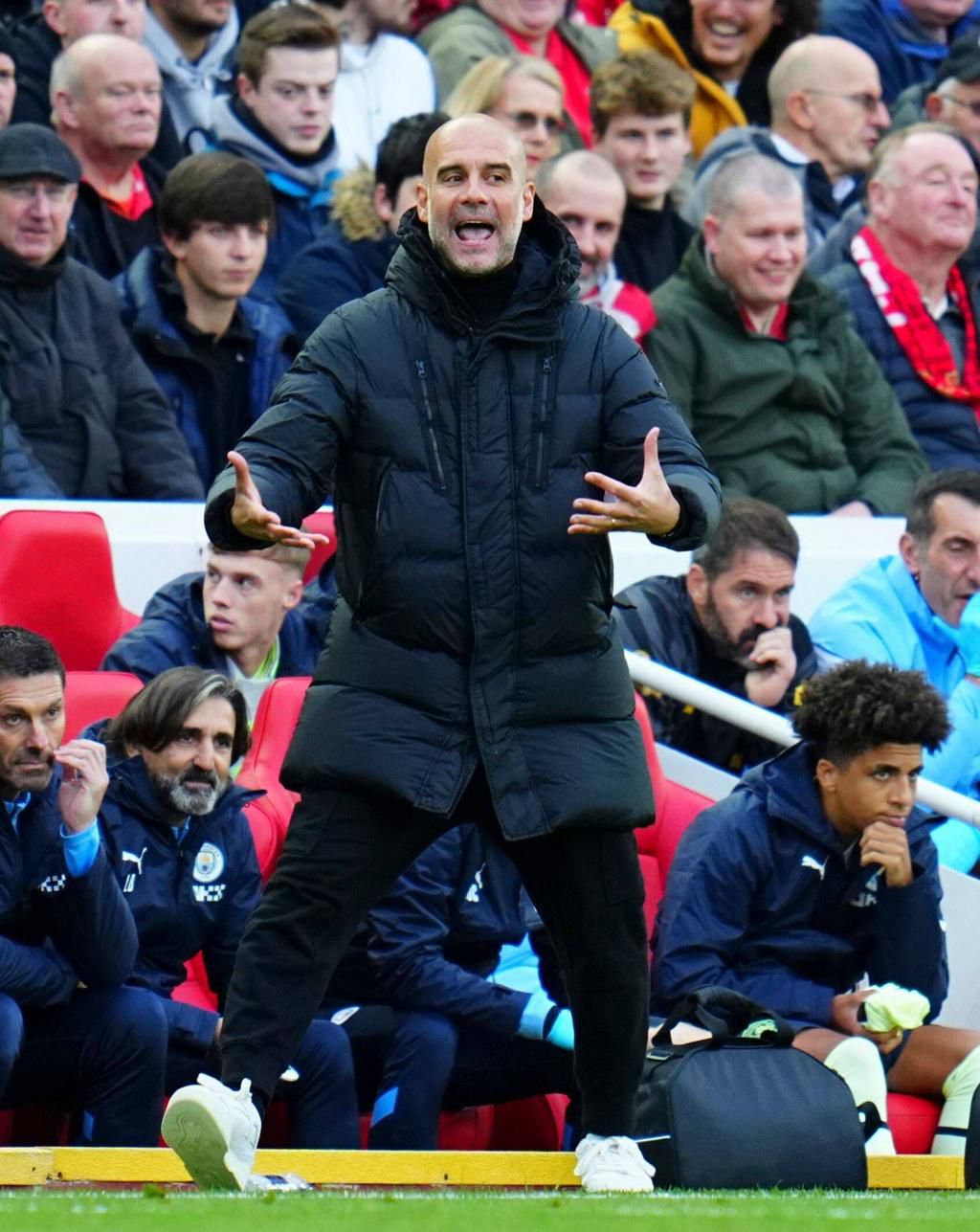 Manchester City manager Pep Guardiola reacts on the dugout.