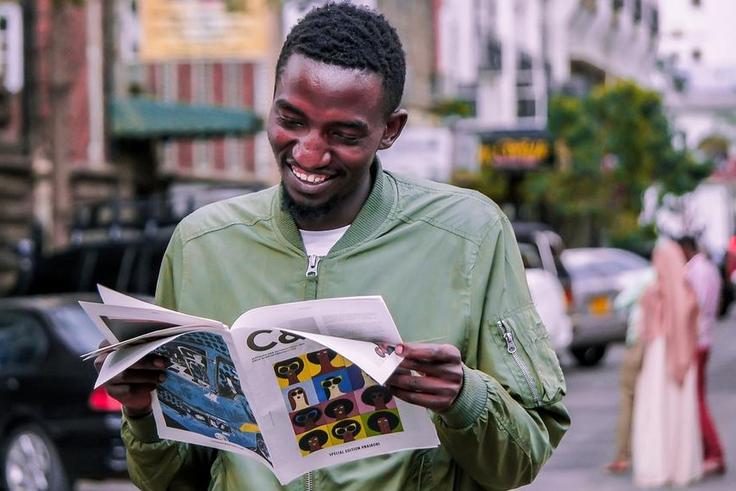 A photo of a man reading a booklet. Photo credits: Pixabay