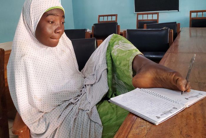 Maryam Umar writing with her leg.