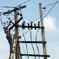 A power official works on an electric pole along a street in Nigeria's commercial capital Lagos October 3, 2012. REUTERS/Akintunde Akinleye