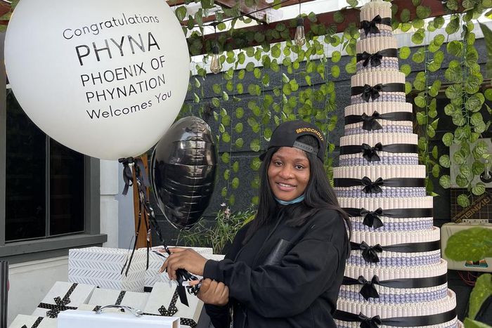 Phyna posing next to a money tree presented to her by Phyna-nation